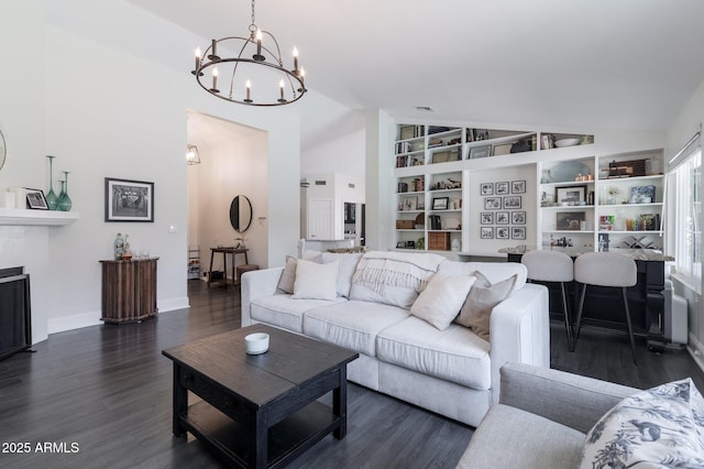 4313 E Briarwood Ter, Phoenix, AZ 85048 - living area featuring vaulted ceiling, a chandelier, built in features, wood finished floors, and baseboards