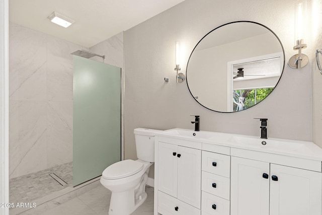 bathroom with toilet, marble finish floor, a walk in shower, and a sink