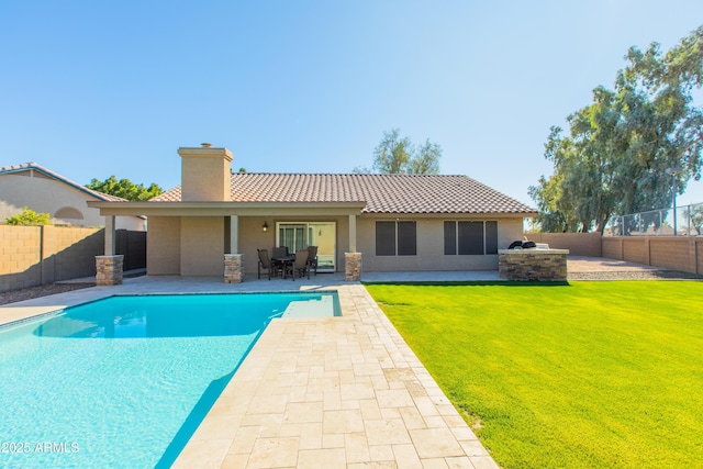 view of swimming pool featuring a patio area, a yard, and area for grilling