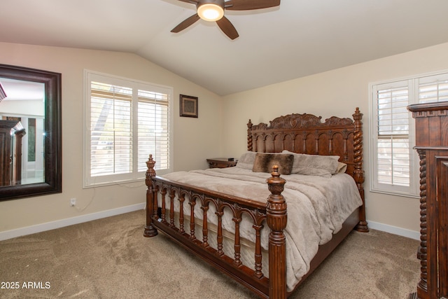 bedroom featuring ceiling fan, light colored carpet, vaulted ceiling, and multiple windows