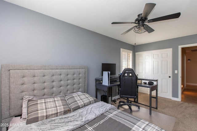 bedroom with ceiling fan, carpet, and a closet