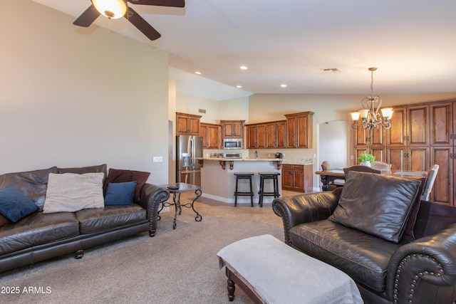 living room featuring light colored carpet, vaulted ceiling, and ceiling fan with notable chandelier