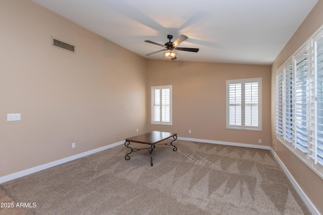 unfurnished room featuring vaulted ceiling, ceiling fan, and light colored carpet