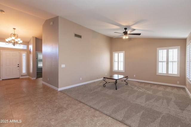 spare room with lofted ceiling, light carpet, and ceiling fan with notable chandelier