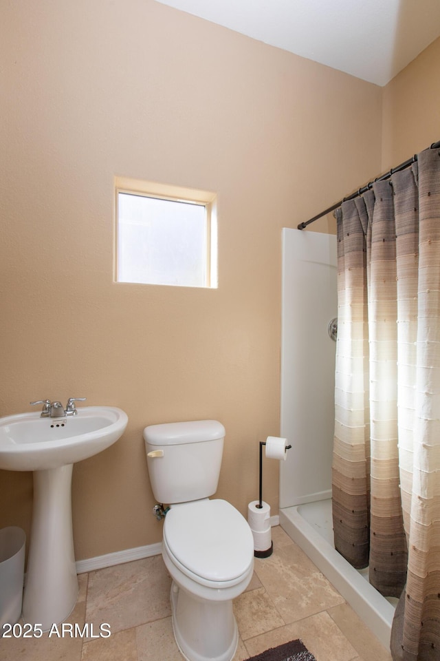 bathroom with sink, toilet, and a shower with shower curtain