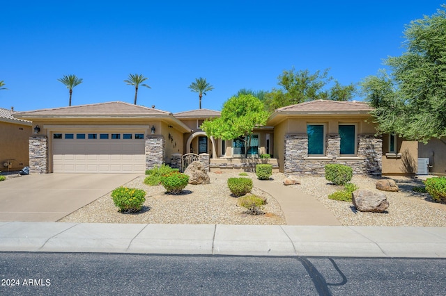 prairie-style house with an attached garage, stone siding, concrete driveway, and stucco siding