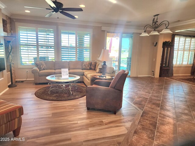 living room featuring light hardwood / wood-style floors, crown molding, vaulted ceiling, and ceiling fan