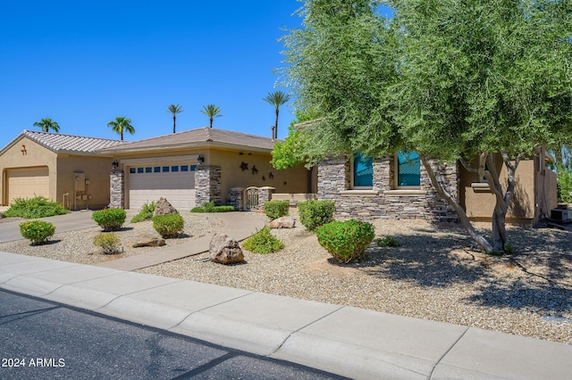 view of front of home with a garage, stone siding, concrete driveway, and stucco siding