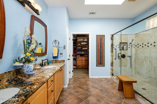 kitchen with ornamental molding, light brown cabinets, stainless steel refrigerator with ice dispenser, and hanging light fixtures