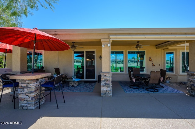 view of patio / terrace featuring ceiling fan, outdoor dry bar, and outdoor dining area