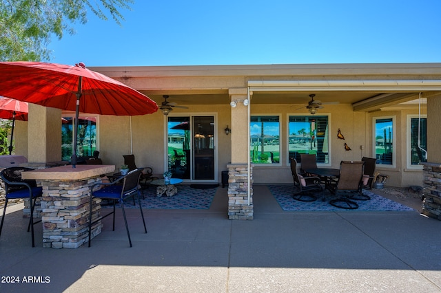 view of patio with an outdoor bar and ceiling fan