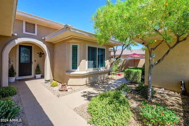 entrance to property featuring stucco siding