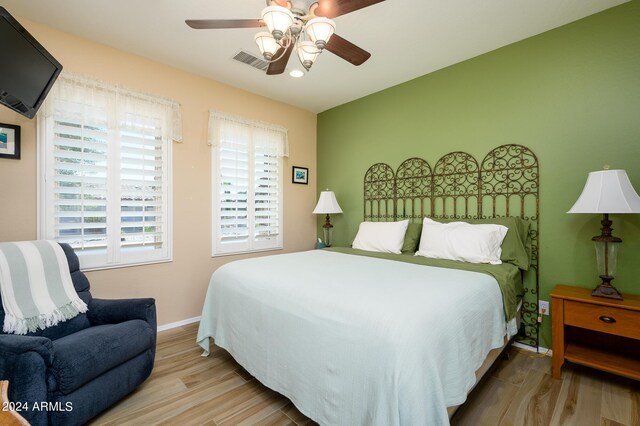 bedroom with ceiling fan and hardwood / wood-style flooring