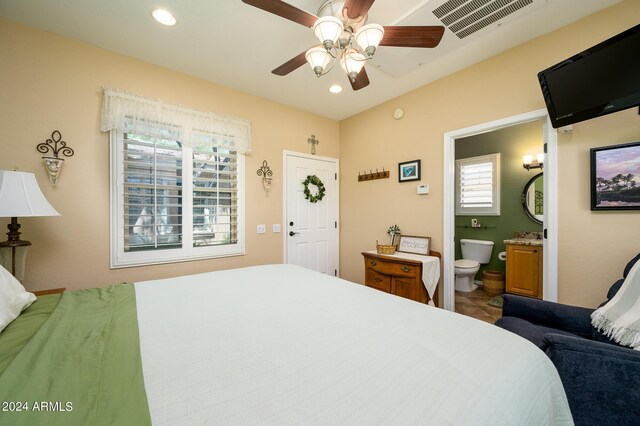 bedroom with ceiling fan and ensuite bath