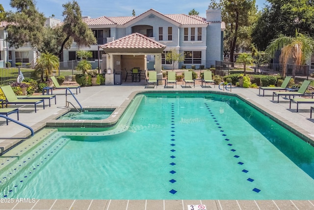 view of pool with a community hot tub and a patio