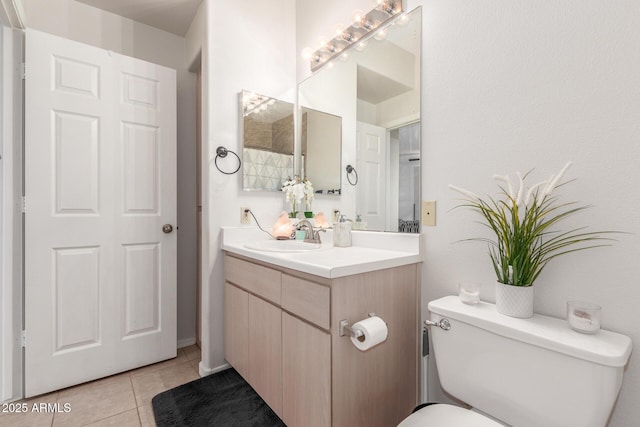 bathroom featuring tile patterned floors, vanity, and toilet