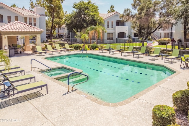 view of swimming pool with a patio and a hot tub