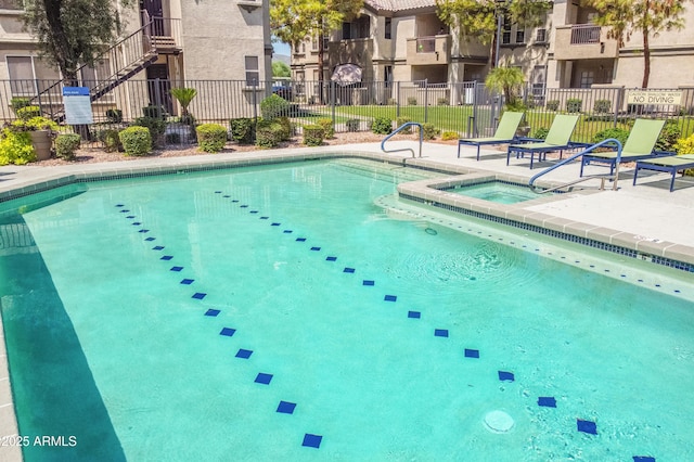 view of swimming pool with a community hot tub