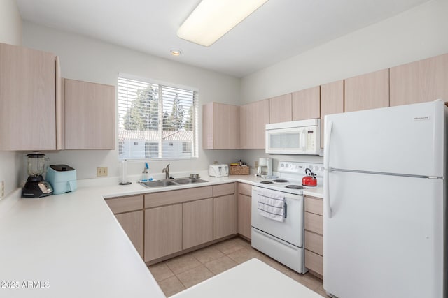 kitchen featuring light brown cabinetry, sink, light tile patterned floors, and white appliances