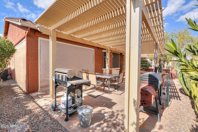 view of patio with area for grilling and a pergola