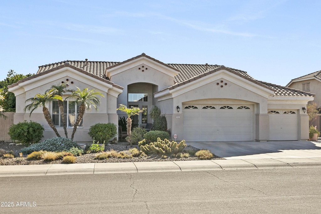 mediterranean / spanish home featuring a garage