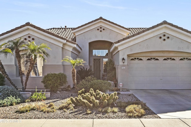 mediterranean / spanish-style home featuring a garage