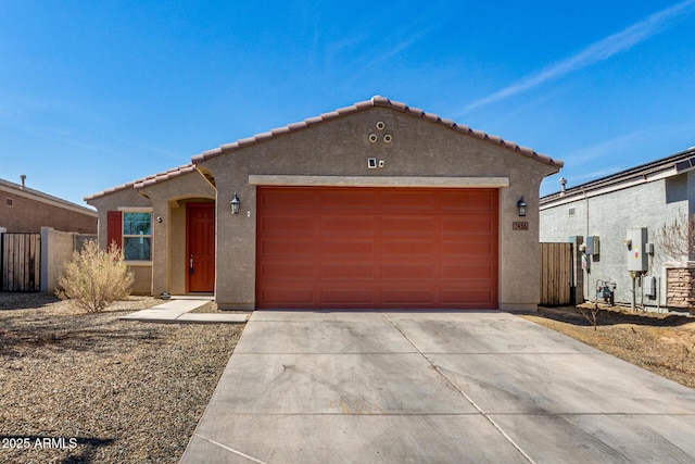 view of front of property with stucco siding, a tile roof, an attached garage, and fence