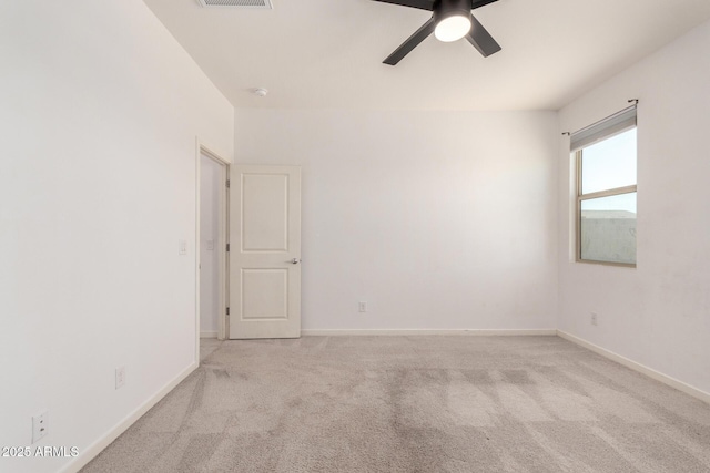 empty room featuring visible vents, carpet floors, baseboards, and ceiling fan