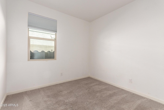 spare room with carpet flooring and baseboards