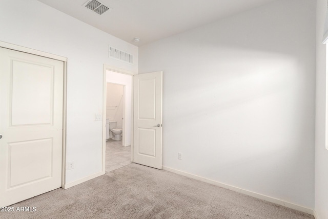 unfurnished bedroom with baseboards, visible vents, and carpet floors