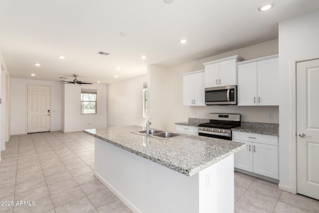 kitchen featuring visible vents, recessed lighting, stainless steel appliances, white cabinetry, and a sink