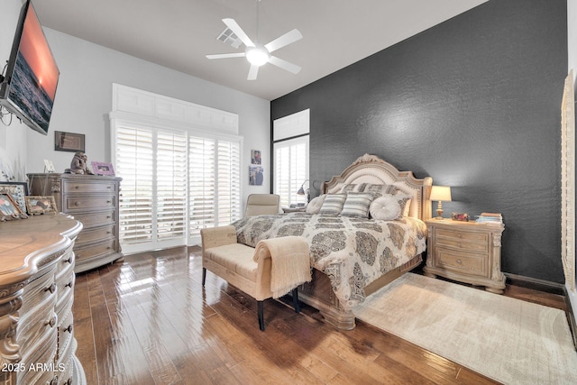 bedroom with ceiling fan and hardwood / wood-style flooring