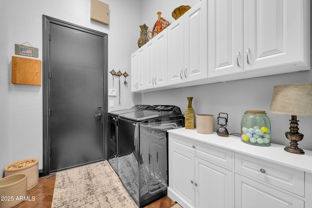 laundry area featuring washer and dryer and cabinet space