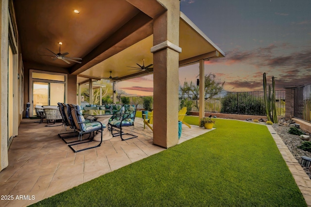 view of patio featuring fence and a ceiling fan