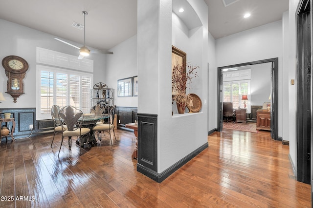 dining space featuring recessed lighting, a high ceiling, visible vents, baseboards, and hardwood / wood-style floors