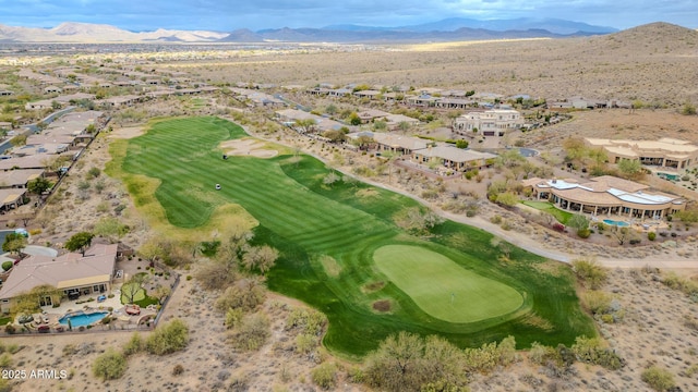 drone / aerial view featuring view of golf course and a mountain view