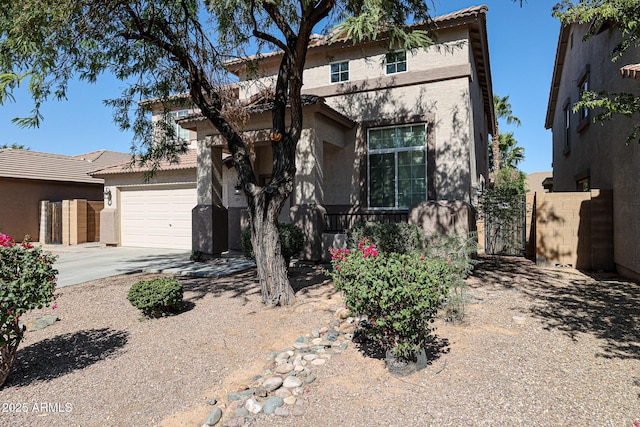 view of front of home featuring stucco siding, driveway, an attached garage, and a tiled roof