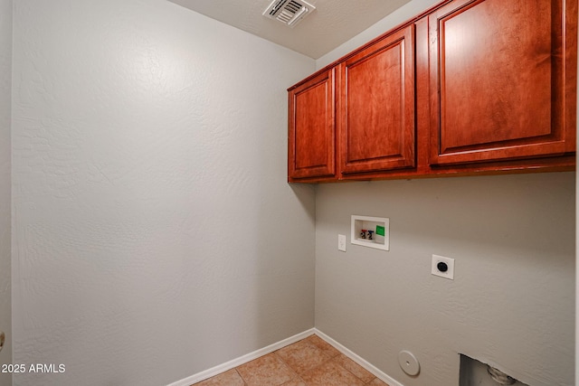 clothes washing area featuring hookup for a washing machine, visible vents, hookup for an electric dryer, cabinet space, and hookup for a gas dryer