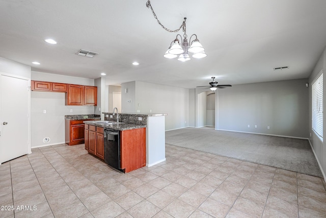 kitchen with black dishwasher, brown cabinetry, visible vents, and a sink