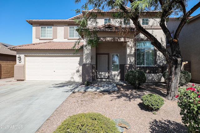 view of front of home with stucco siding, a garage, driveway, and a tiled roof