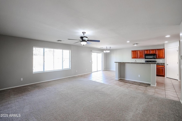 unfurnished living room with light tile patterned floors, visible vents, light carpet, and recessed lighting