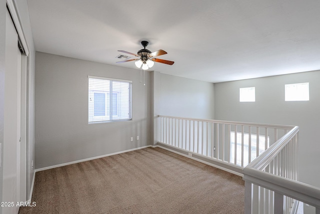 unfurnished room with visible vents, baseboards, and carpet flooring