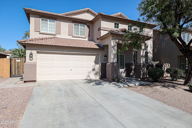 mediterranean / spanish-style home featuring stucco siding, an attached garage, driveway, and a tiled roof