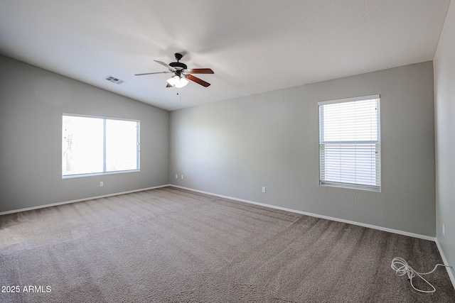 unfurnished room featuring a ceiling fan, carpet, visible vents, baseboards, and lofted ceiling