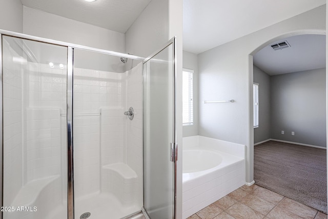 bathroom featuring baseboards, visible vents, a stall shower, tile patterned flooring, and a garden tub