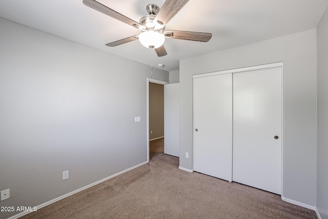 unfurnished bedroom featuring a closet, carpet floors, baseboards, and a ceiling fan