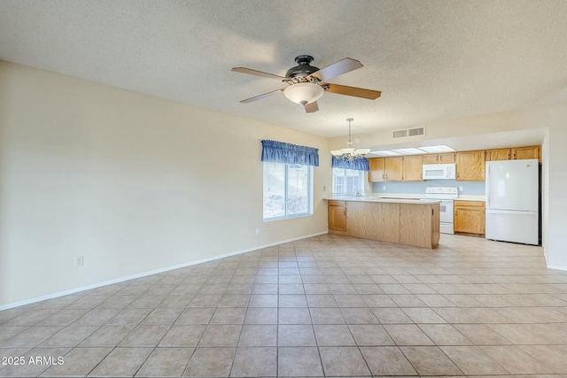 kitchen with white appliances, visible vents, baseboards, a peninsula, and light countertops