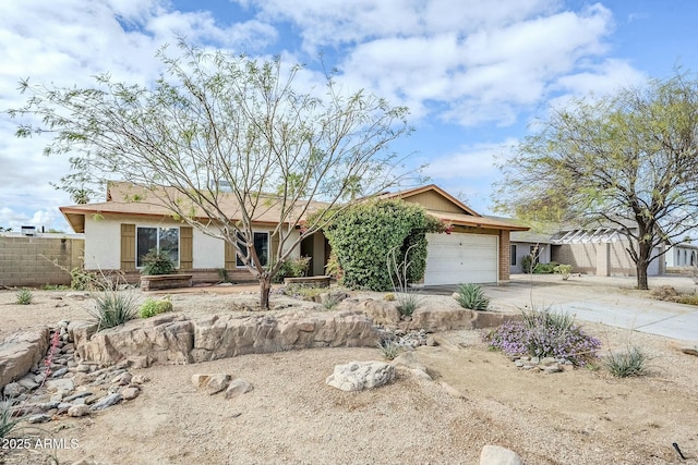 ranch-style house featuring stucco siding, concrete driveway, a garage, and fence