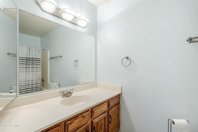 bathroom featuring a shower with curtain, toilet, and vanity