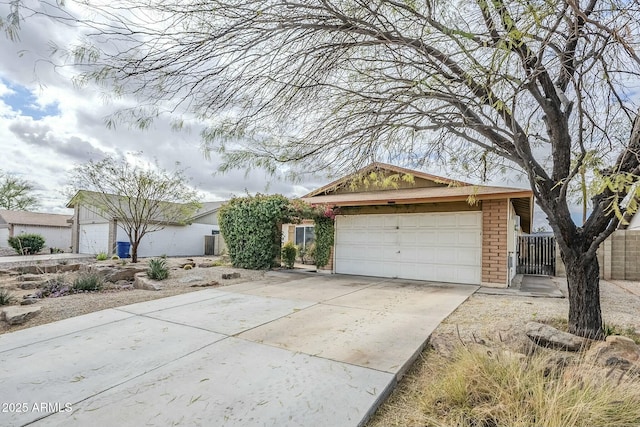 ranch-style home featuring brick siding, concrete driveway, and a garage